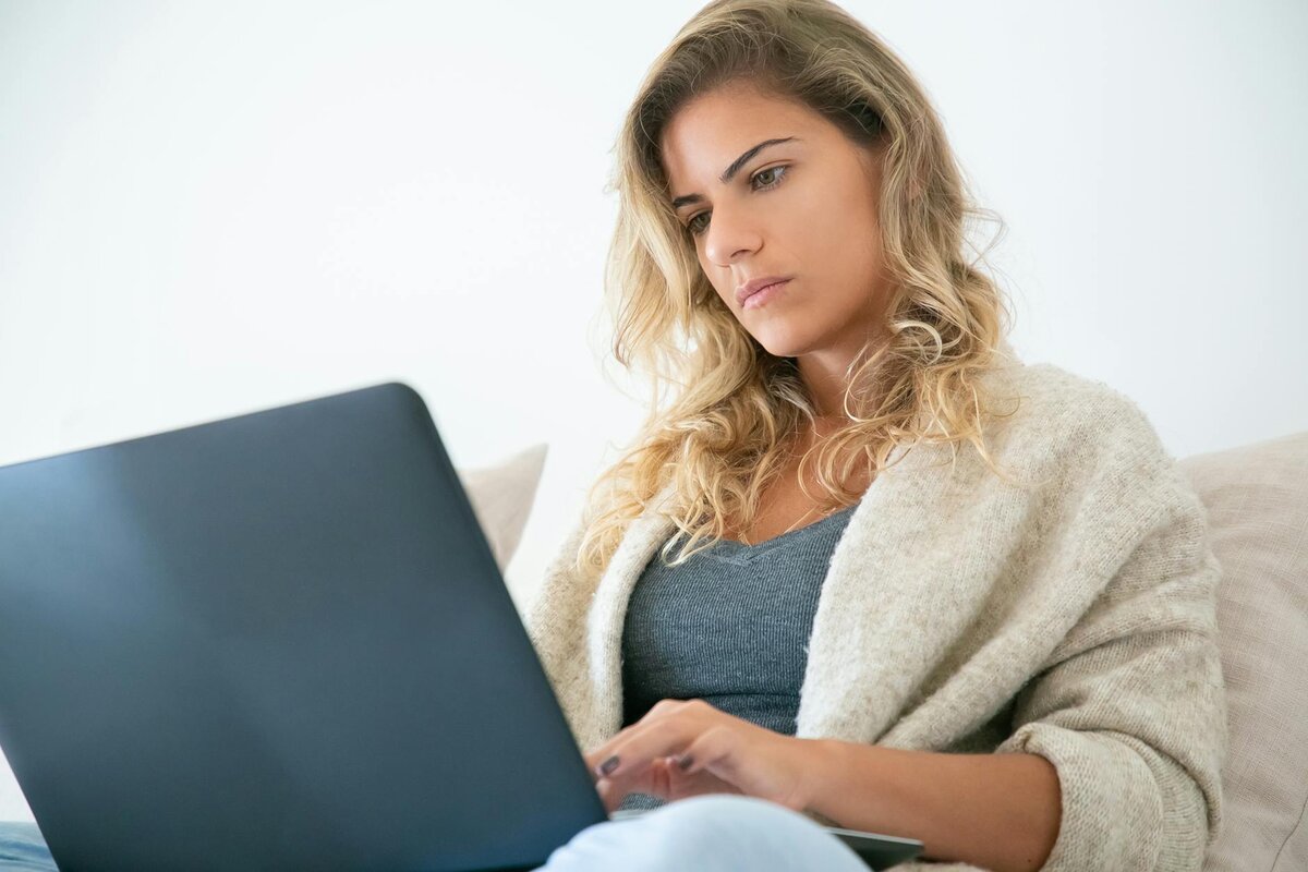 woman sitting and focused on her laptop