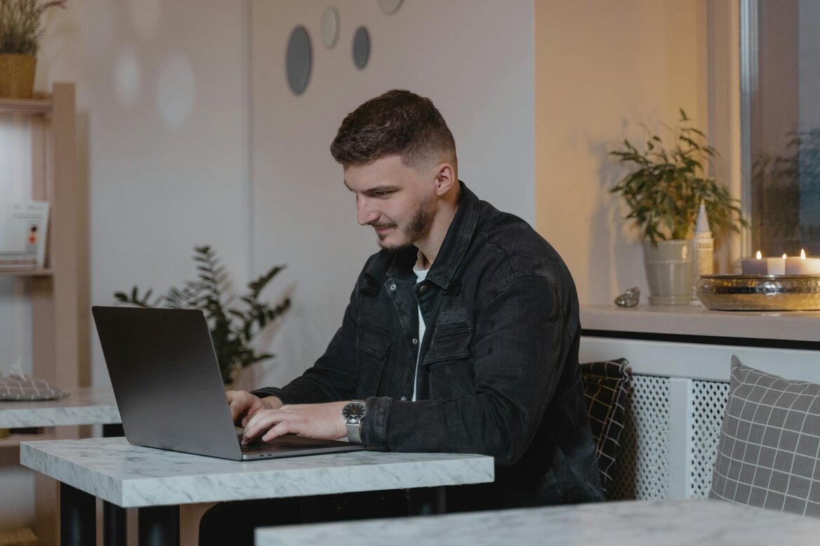 Person working on laptop at a table