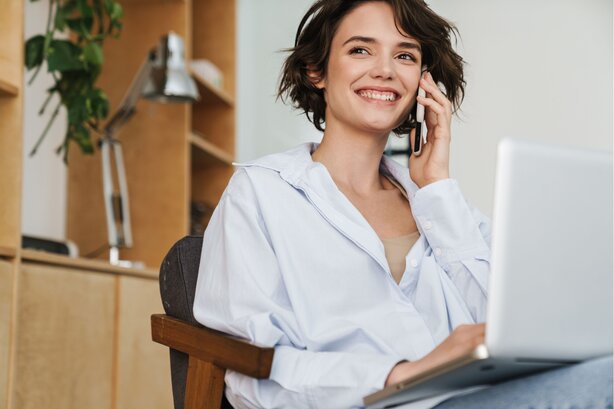 Woman working on laptop in bright modern office