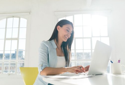 happy woman using her laptop