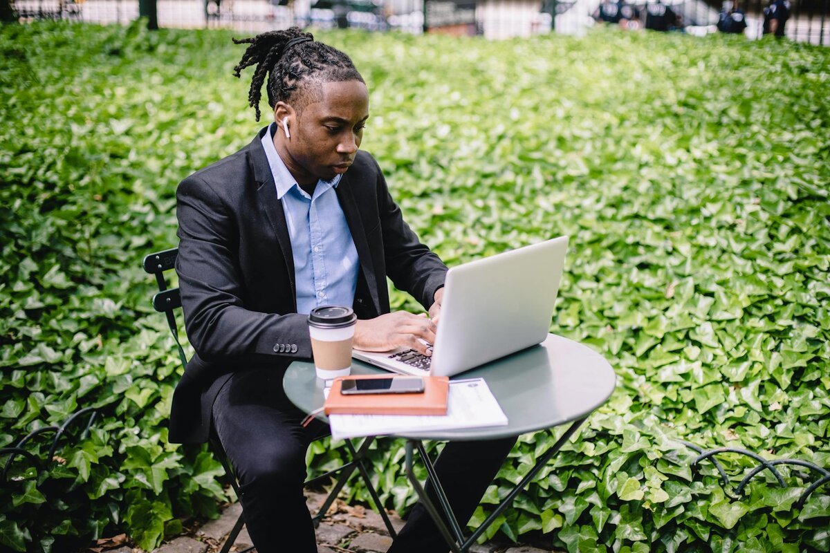 man with laptop and cup of coffee