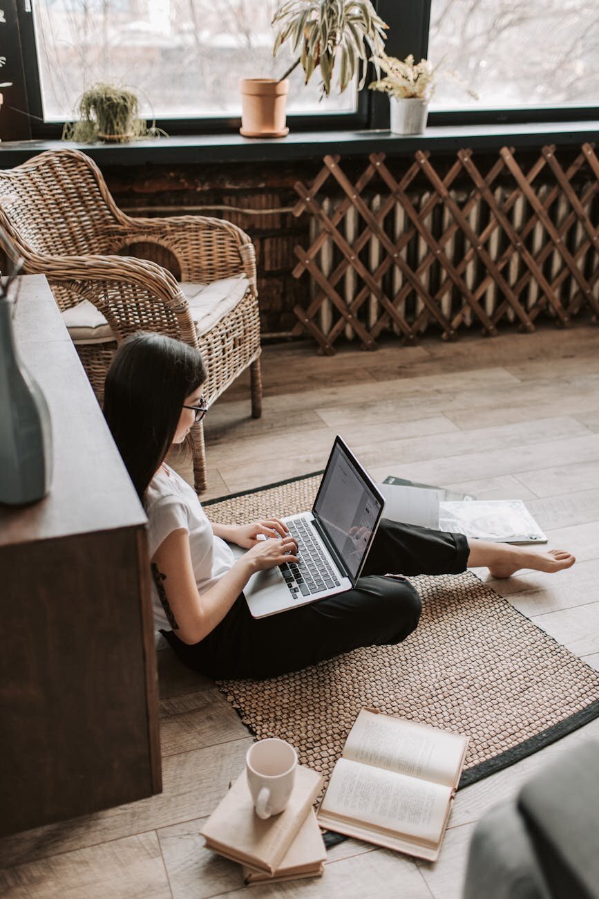 Woman sitting on the floor with a laptop