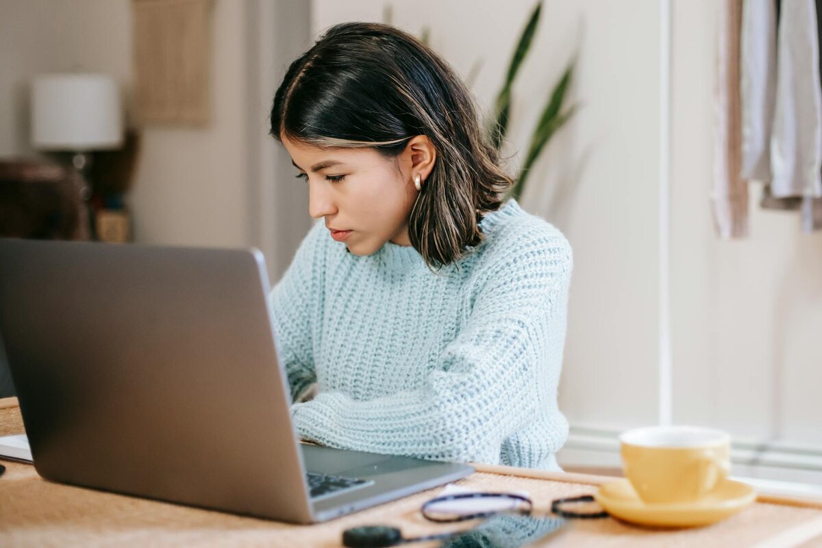 Woman working on her laptop checking the tax guide on the internet