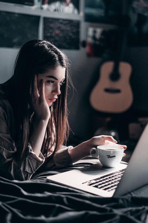 lady looking at a laptop thinking 