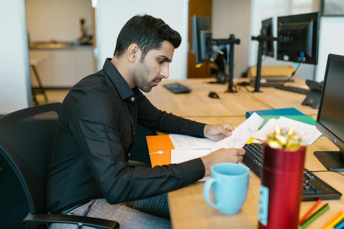 Man working on his computer checking his report