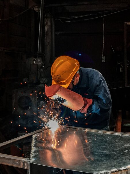 man welding sheet steel