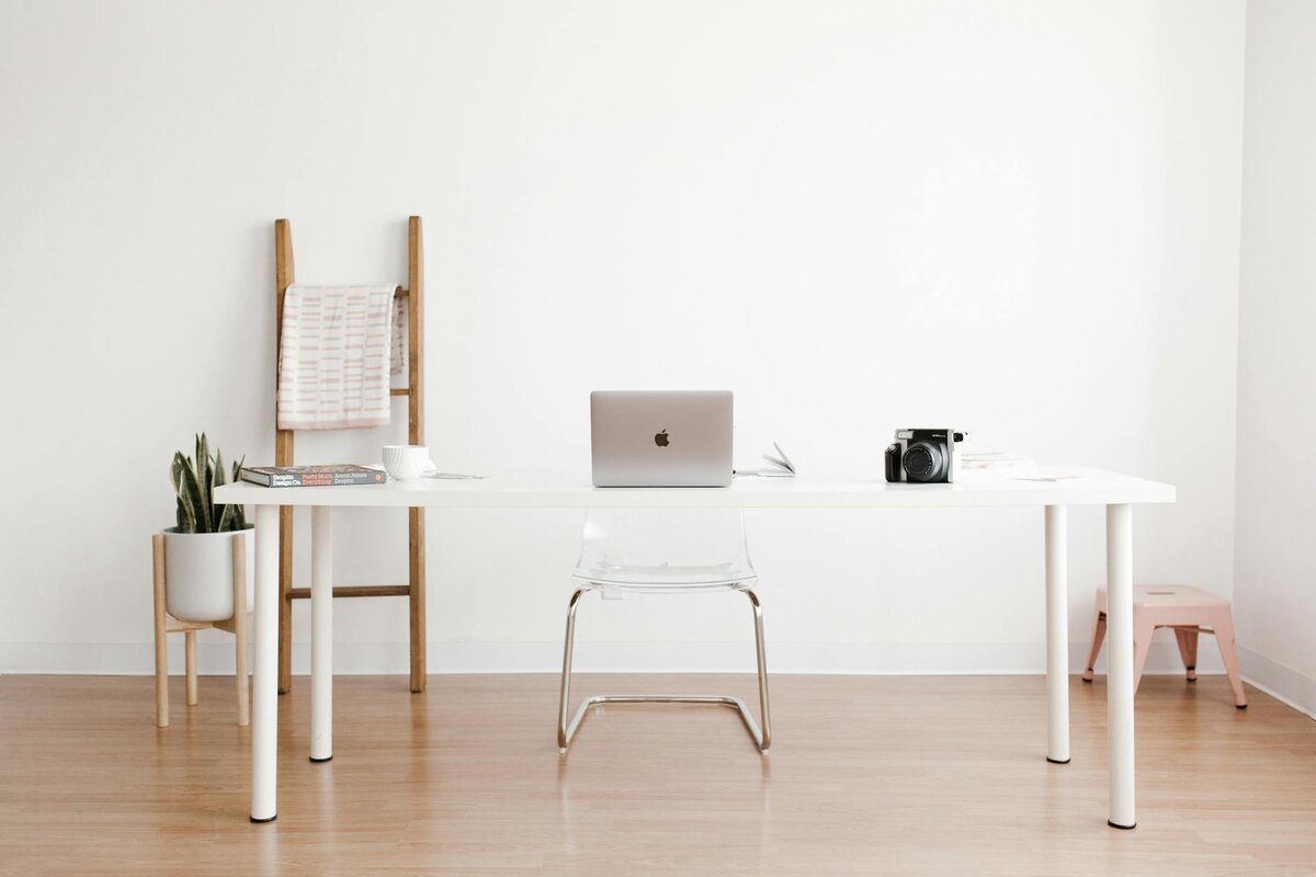 laptop on table with char behind it 