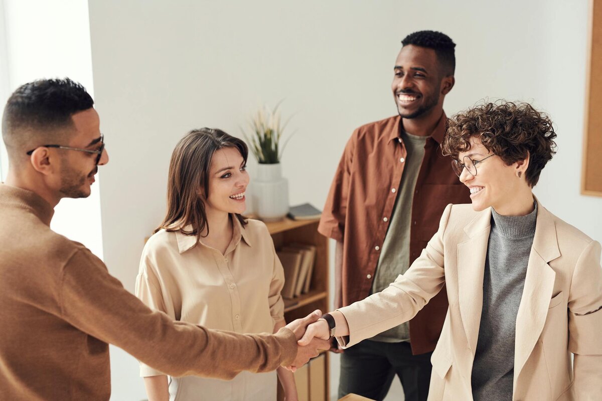 Group of four people and handshake