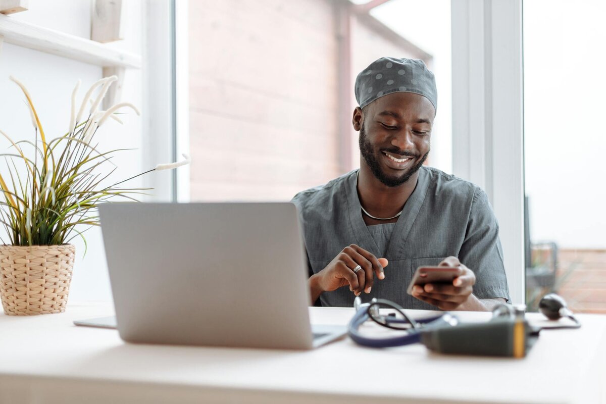 a man sitting at a desk working from his laptop 