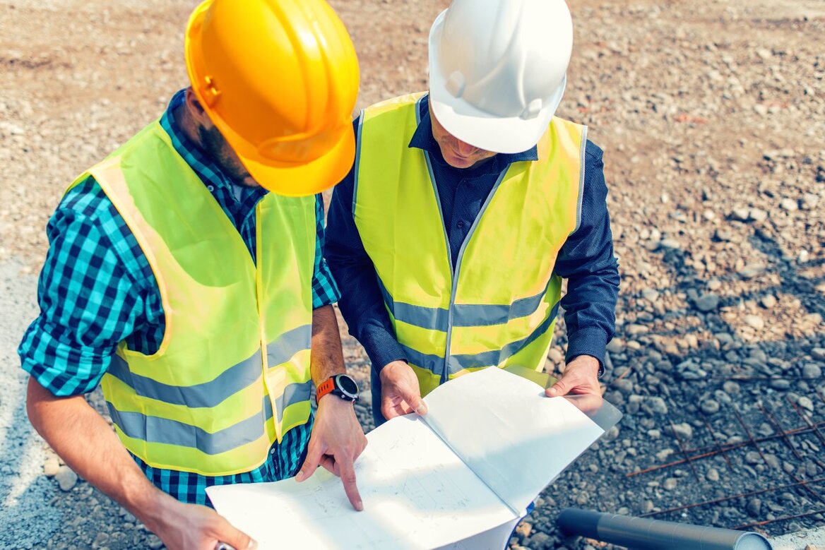 CIS contractors reviewing project documents on a construction site