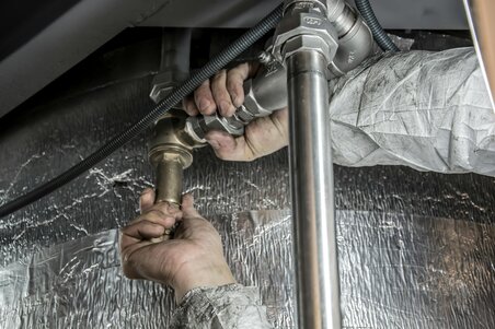 man fixing tubes silver