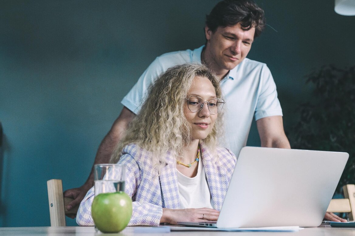 women with a man working on laptop