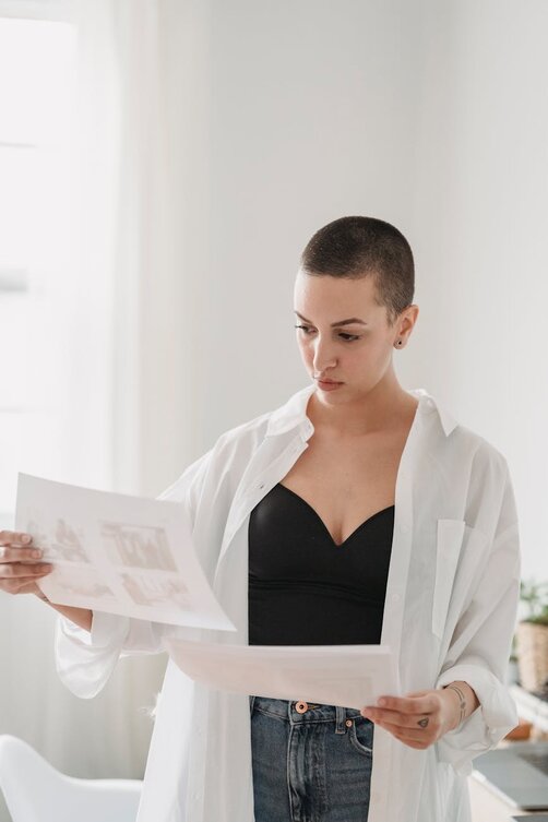 woman holding paper with images 