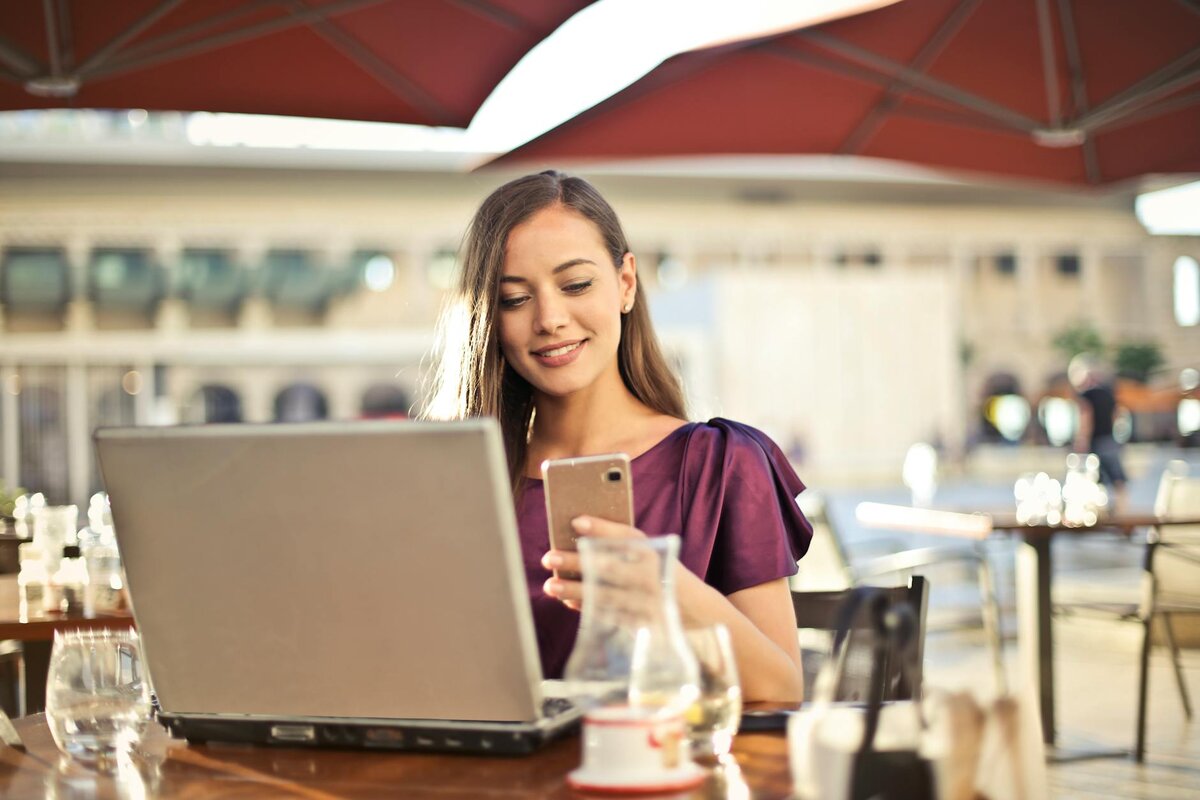 picture of a women working on a laptop with a cup of coffee 