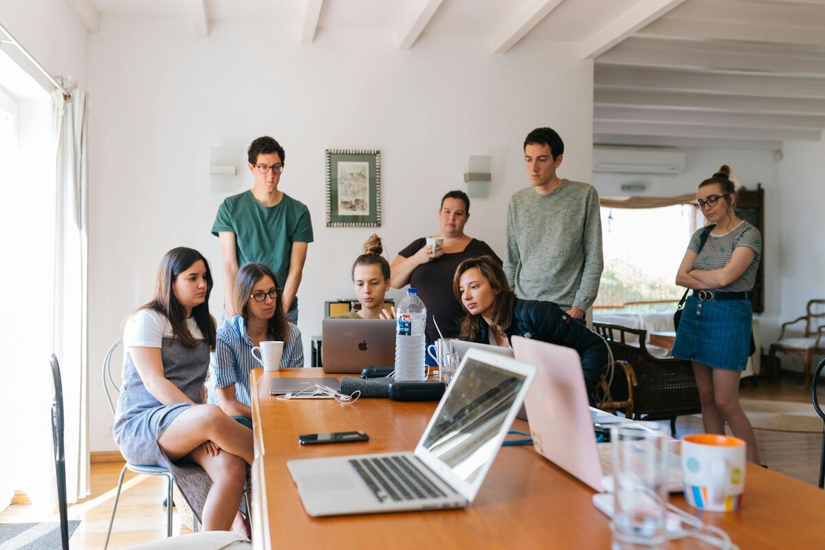 people around a laptop
