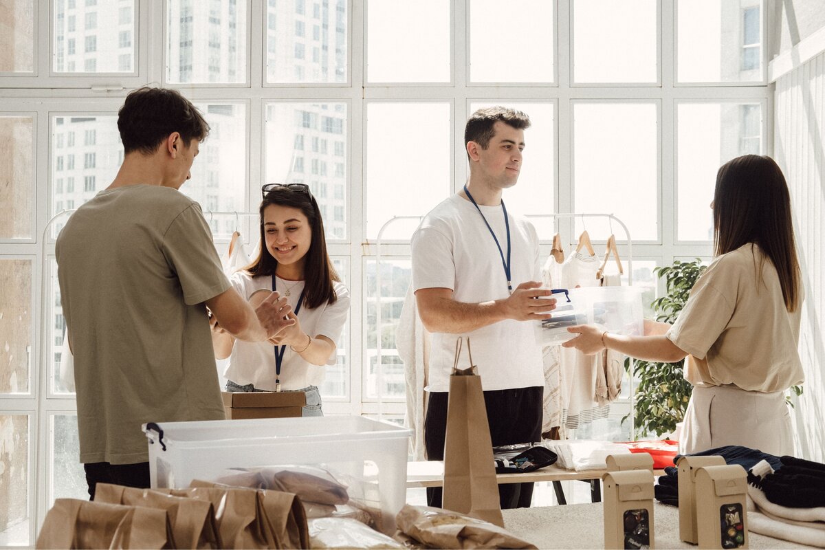 Small business team handling customer orders and inventory in a retail workspace