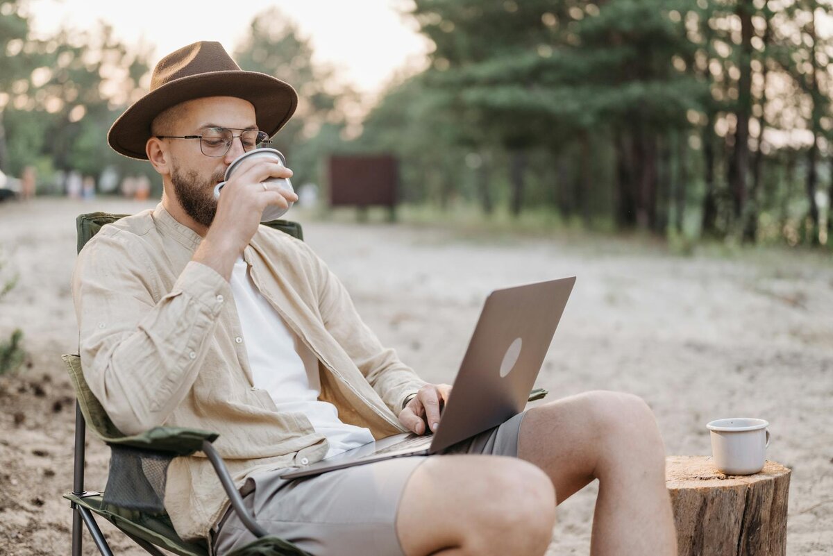 Man searching in his laptop about what counts as foreign income