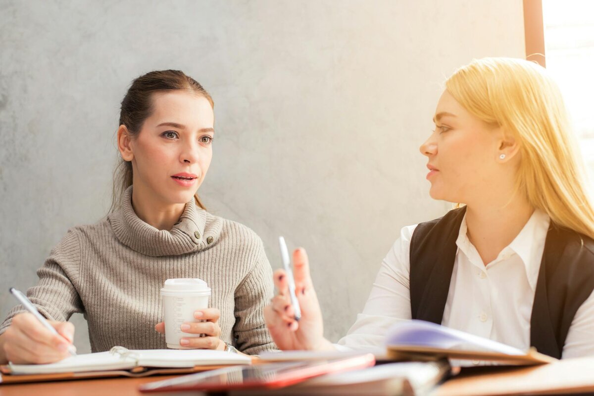two women working and talking 