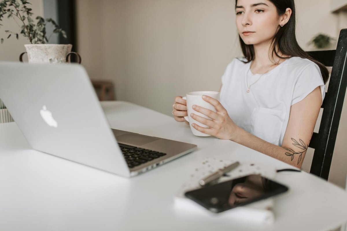 Woman focused in her laptop reading about the guide on Payment on Account