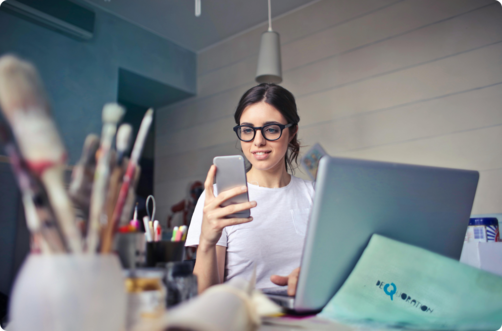 woman with glasses checking phone