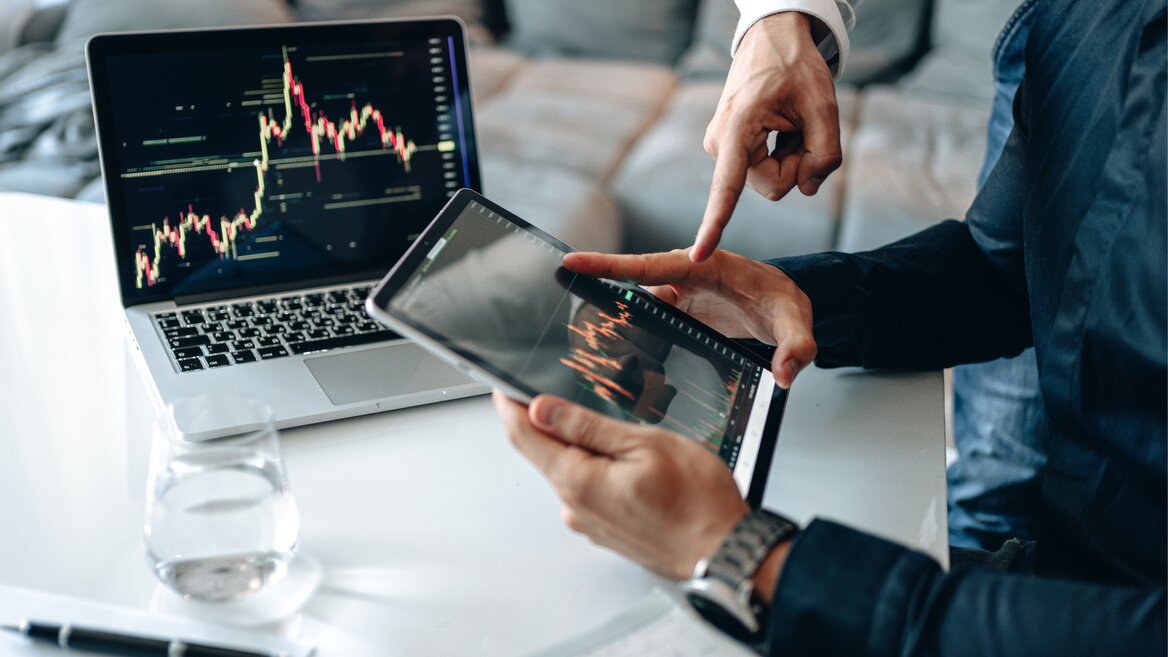 Investors reviewing cryptocurrency trading charts for crypto income tax reporting