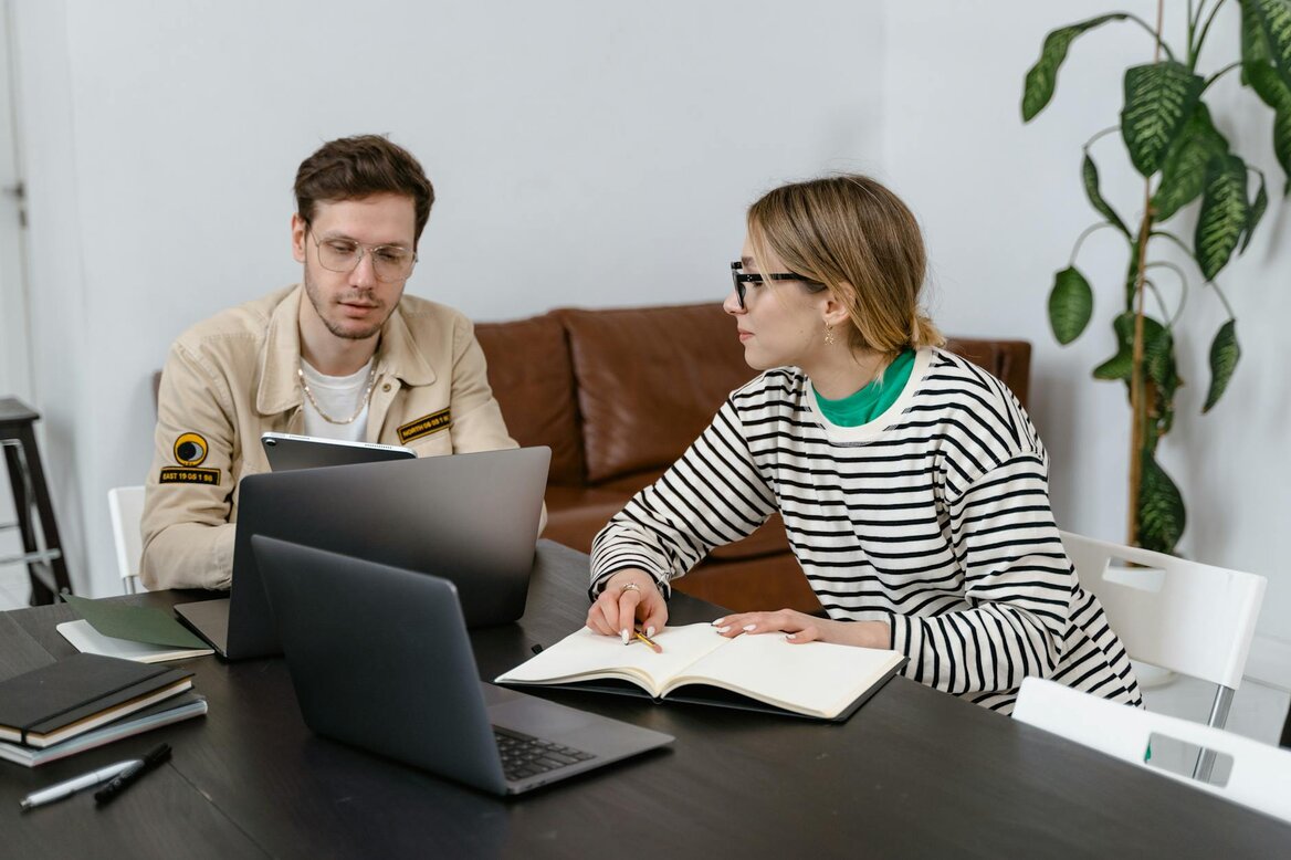 man and woman on laptops 