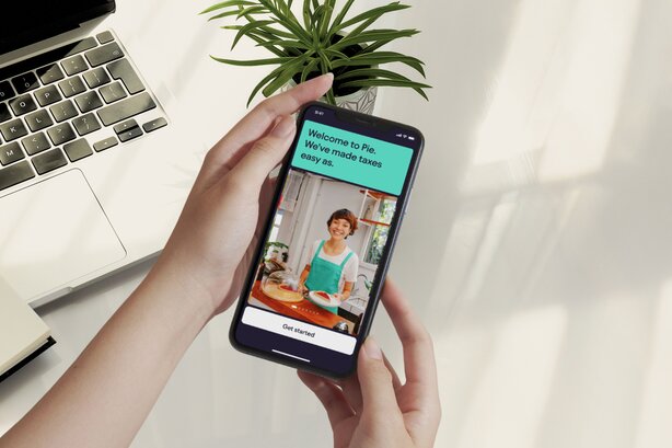 Person holding smartphone displaying finance management mobile application.