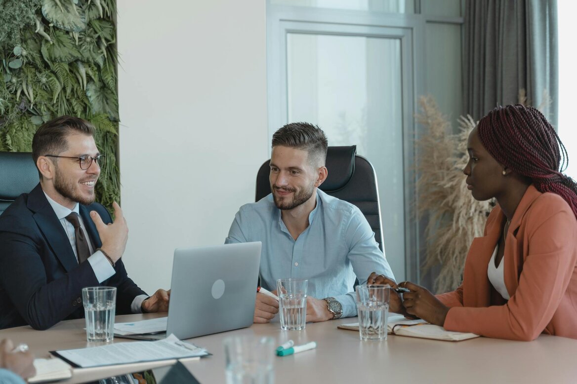 Business professionals discussing AI accounting software benefits during collaborative office meeting