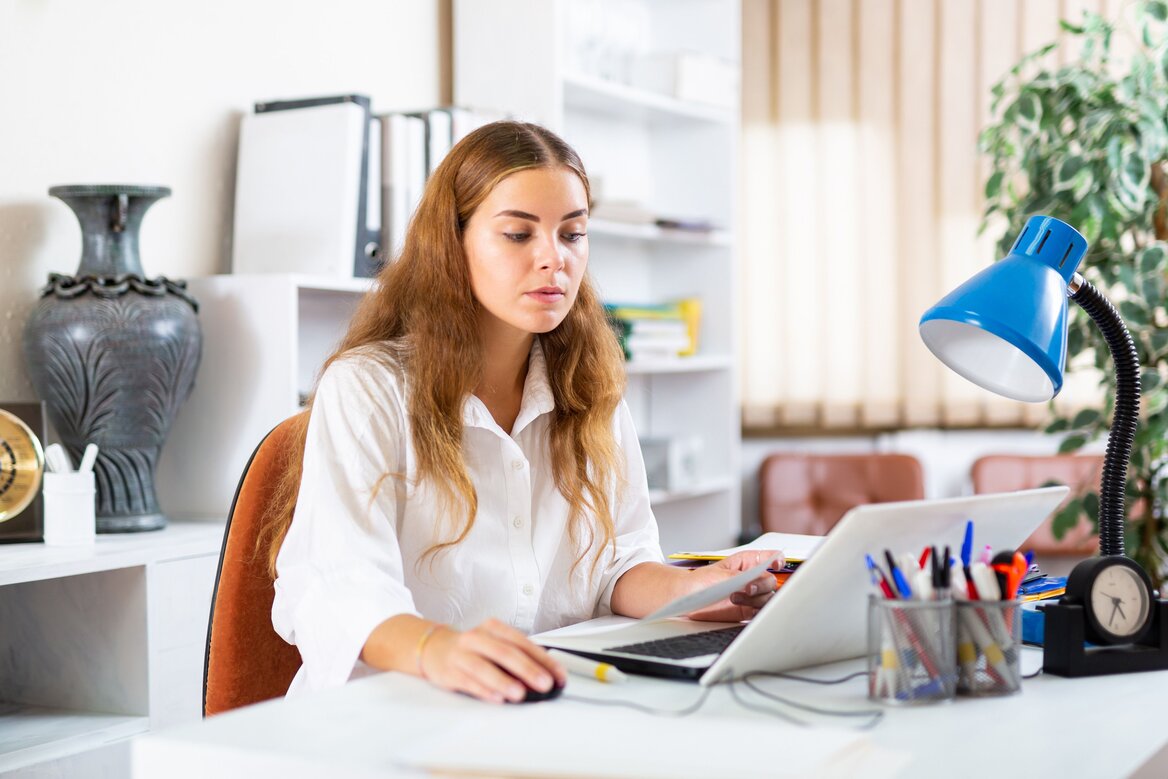 Self-employed woman managing finances and Universal Credit on a laptop at home