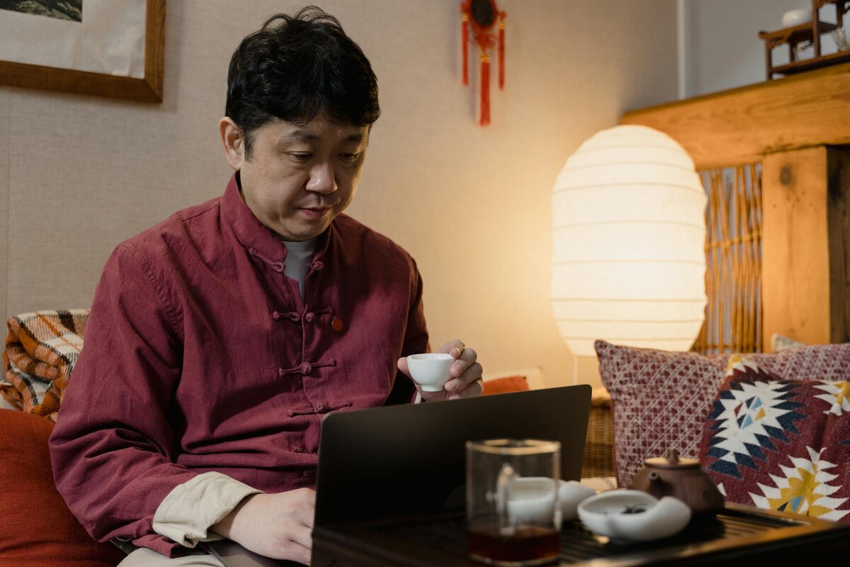 man with a laptop and cup of coffee