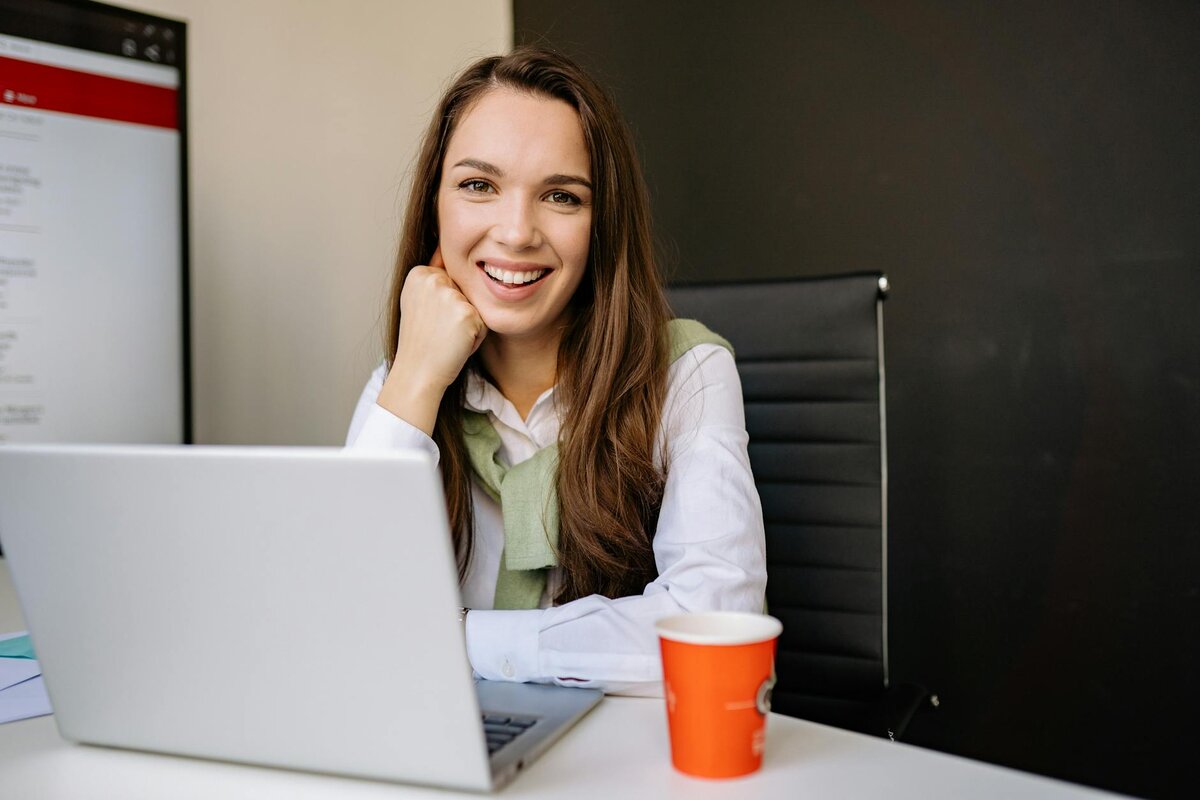 Focused woman working on her laptop searching UK tax guide