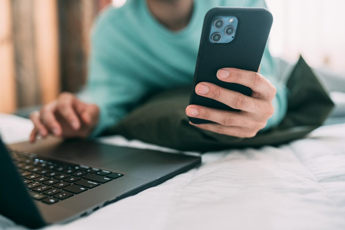 someone on phone and laptop