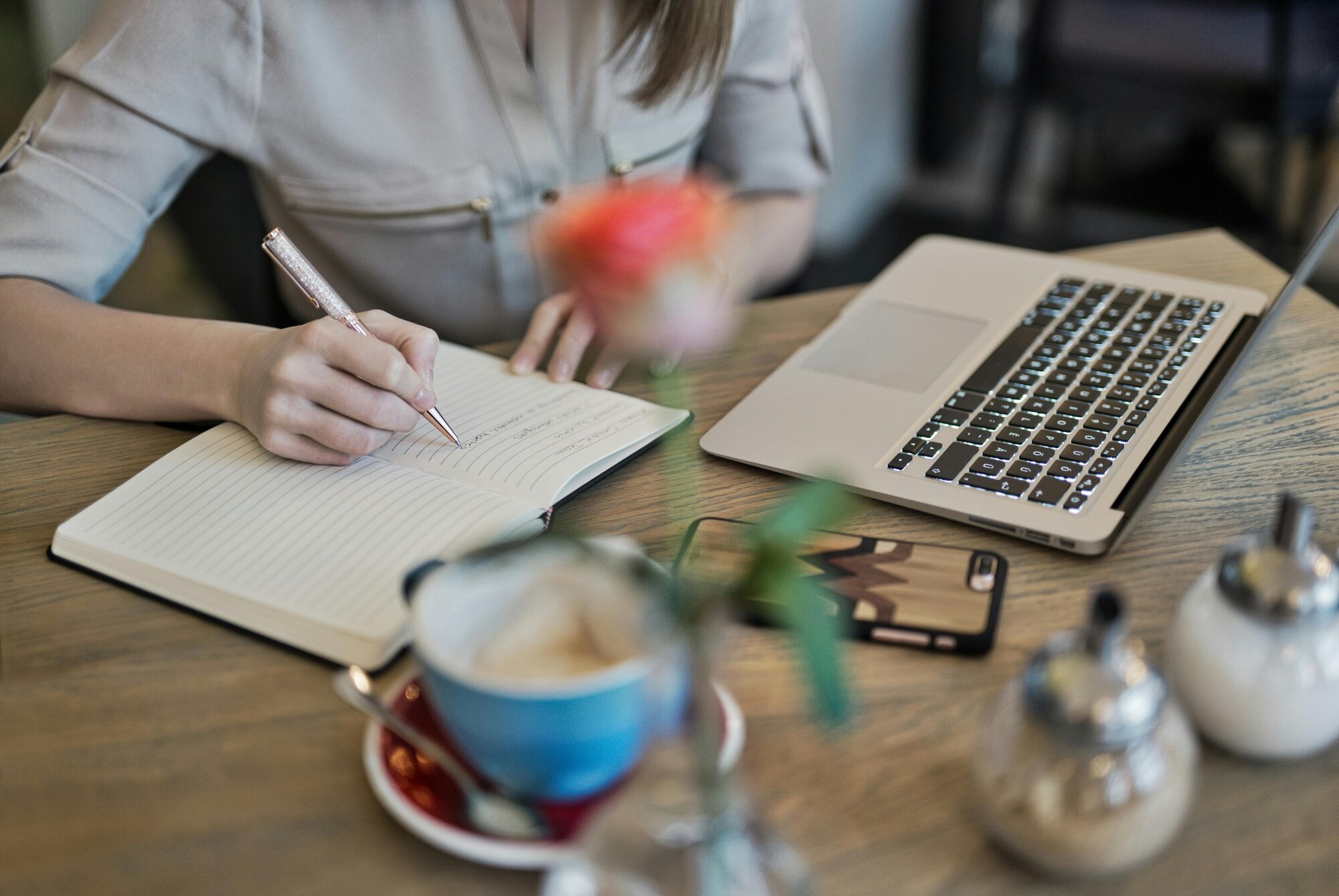 woman writing on notebook